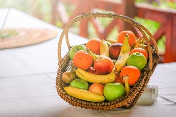 A basket with lot of different fruit on the table. Wedding table decoration in restaurant
