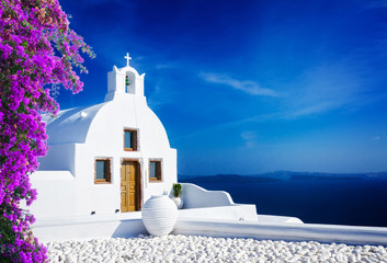 beautiful details of Santorini island - typical house with white walls and blue Aegan sea, Greece