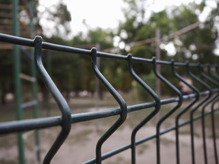 Mesh iron fence. Close-up