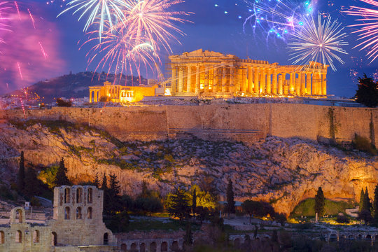 Famous skyline of Athens with Acropolis hill and Pathenon illuminated at night with fireworks, Athens Greecer