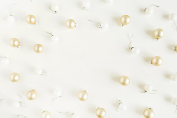 Mockup frame of golden Christmas balls decorations on white background. Flat lay, top view Christmas / New Year holiday composition.