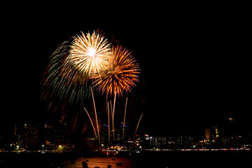 Fototapeta premium Many flashing fireworks with night cityscape background celebrate New Year.