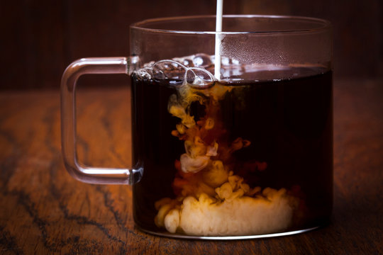 Cream Being Poured Into Coffee