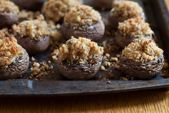 Close up of mushrooms with crumble topping on baking pan