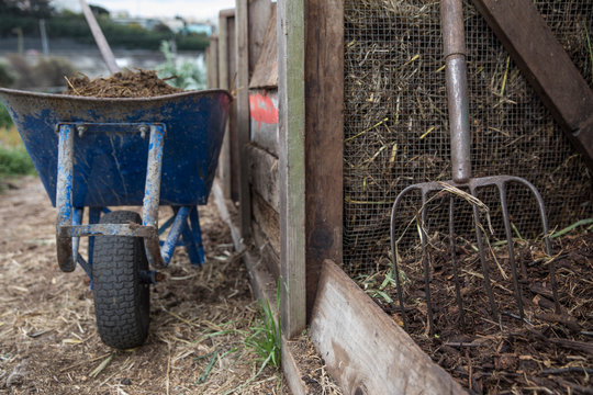 Wheelbarrow and rake on a farm
