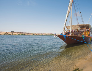 Obraz premium Large egyptian dahabeya river boat moored on the Nile