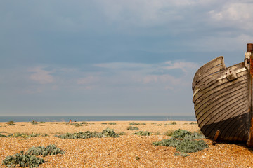 Part of an old wooden fishing boat on the pebble beach at Dungeness
