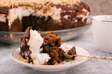 Leftover cake after dinner. Dishes for dessert white. Light background.