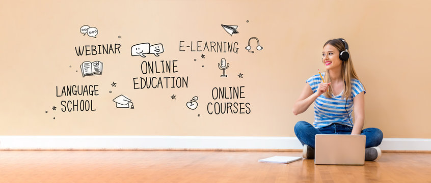 Online education theme with young woman with headphones using a laptop computer and a pencil