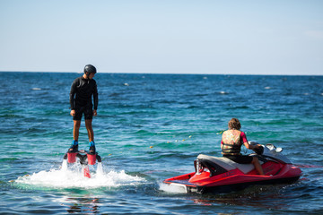 Silhouette of a fly board rider at sea