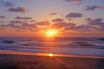 Naklejka na ściany i meble A magical wonderful sunset on the shores of the Mediterranean in Israel, Tel Aviv..