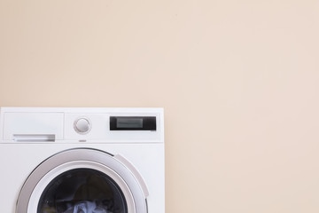 Washing machine and space for text on color background. Laundry day