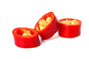 Slices of red chili pepper on white background