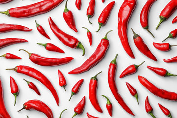 Flat lay composition with fresh chili peppers on white background