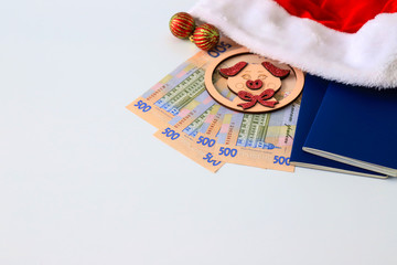 Ukrainian hryvna, banknotes 500 hryvnia, with toy pig 2019,  red Santa Claus hat and blue passport ...