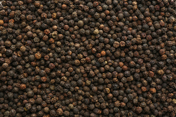 Black pepper corns as background. Natural spice