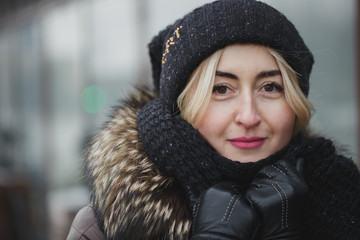 portrait of beautiful happy smiling woman posing outdoors in winter.