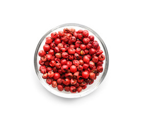 Glass bowl with red peppercorns on white background, top view