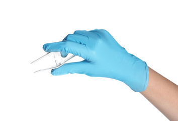 Doctor in medical glove holding disposable forceps on white background