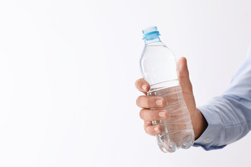Man holding bottle of pure water on white background, closeup. Space for text