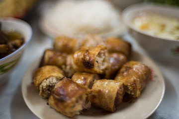Traditional Vietnamese fried springrolls on a plate. Asian food background