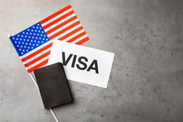 Fototapeta na wymiar Flat lay composition with flag of USA, passport and word VISA on gray background. Space for text