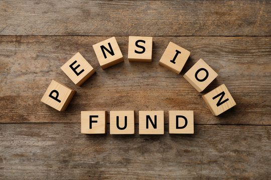 Cubes with words "PENSION FUND" on wooden background