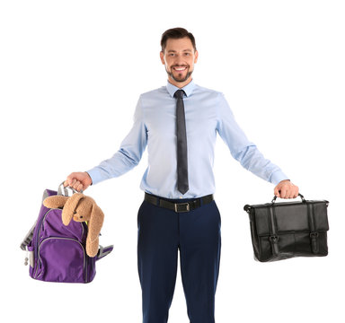 Portrait of businessman holding backpack with toy and briefcase on white background. Combining life and work