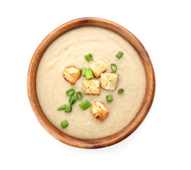 Bowl of fresh homemade mushroom soup on white background, top view