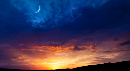 Fototapeta na wymiar Crescent moon with beautiful sunset background . Generous Ramadan . Light from sky . Religion background .Crescent moon with beautiful sunset background . Light from sky . beautiful sky 