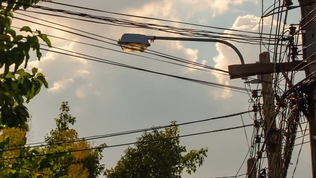 Time lapse, Messy communication and electricity cable with clouds backgraound.