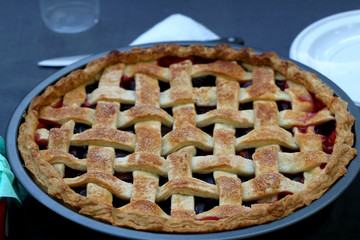 Homemade plum pie on a picnic blanket. Top view, selective focus. 