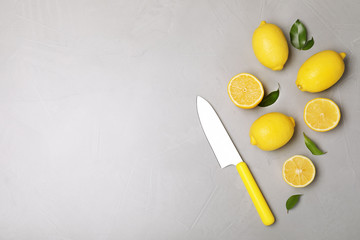 Flat lay composition with fresh lemons and space for text on table