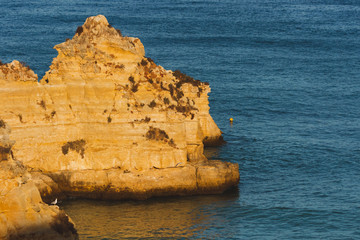 Fototapeta na wymiar Big, giant stones, rocks, boulders, at Praia D. Ana, Lagos, Portugal