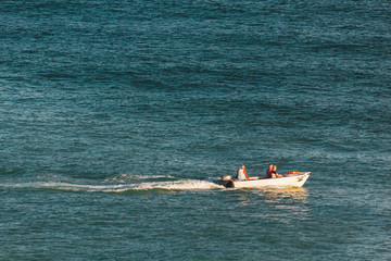 Boat sailing in the ocean near the coast of Lagos, Portugal © Rui