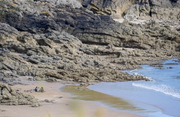 Waves on the beach with cliffs