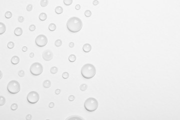 Water drops on white background, top view. Space for text