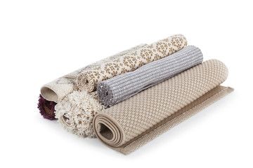 Different rolled carpets on white background. Interior element
