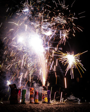 Consumer grade legal fireworks erupt smoke and sparks.