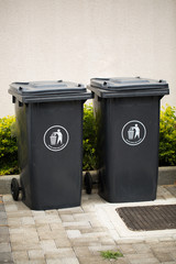 Black indoor waste containers for recycling and garbage. A lot of closed and recycle receptacles trash bin outside