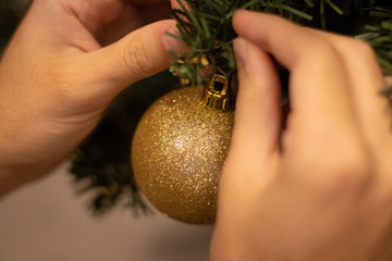 person decorating christmas tree