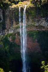 Waterfall flows into the crater of the volcano in Mauritius. National Park Chamarel.