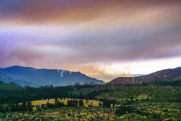 View towards Ferguson Fire burning just outside Yosemite National Park; colorful smoke clouds...