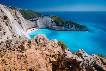 Rock Cliffs in front of Navagio beach Zakynthos. Shipwreck bay with turquoise water and white sand beach. Famous marvel landmark location in Greece