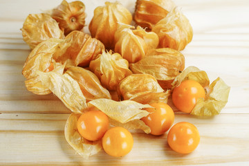 Cape gooseberry fruit on wooden background.