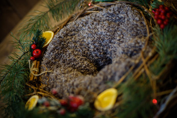 nest of vine with the decor. Christmas wreath. Berries and candied fruits on wreath.