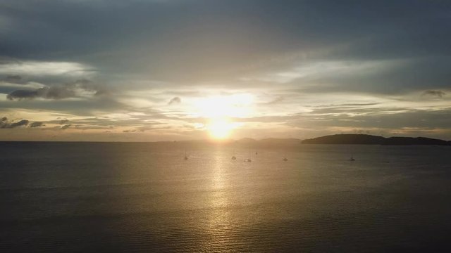 aerial footage yacht ships in sea beautiful seaside during sunset drone flying to sunroads reflecting Thailand Krabi Ao Nang 4k video