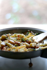 Lyonnaise potatoes are sliced pan-fried potatoes with onion, parsley, butter and garlic. Selective focus.