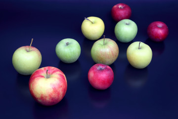 fresh different apples on dark blue background