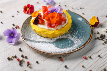 Strawberry tart garnished with edible flowers